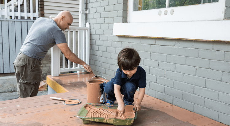 Father and son painting a deck